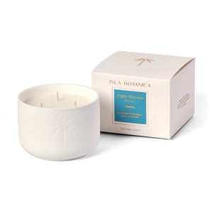White candle with 'Isla Botanica' packaging on a white background