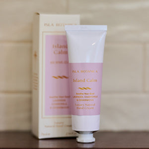 Hand cream and packaging on a wooden surface with a neutral background