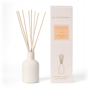 Reed diffuser with decorative box on a white background