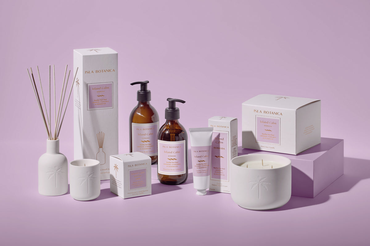 Collection of skincare and home fragrance products on a purple background