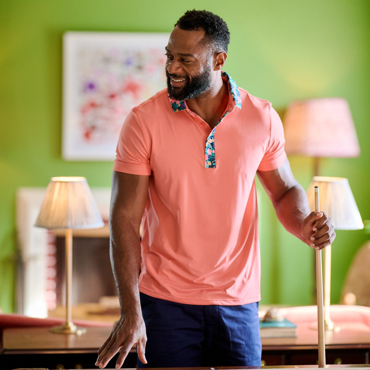 Man coral shirt play pool