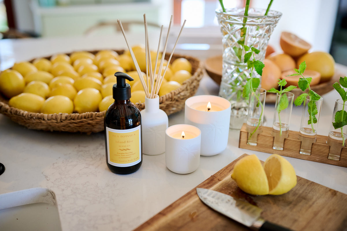 Lemons, candles, and a bottle on a table with a blurred background