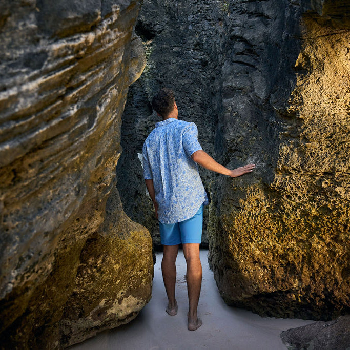 Person exploring a rocky coastal area