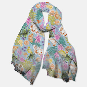 A lightweight multicolor scarf with a floral and animal pattern, displayed in a draped fashion.